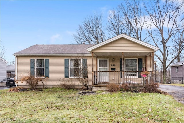 view of front of house with a porch and a front yard