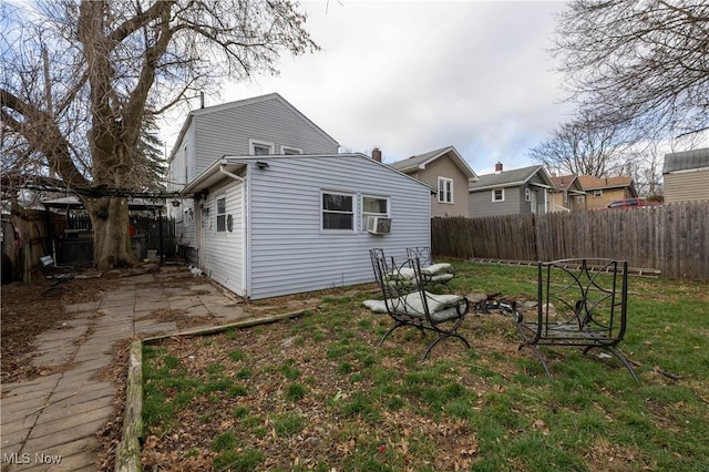 rear view of house with a yard and cooling unit