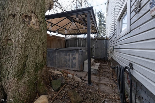 view of patio featuring a gazebo and a hot tub