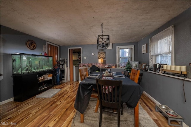 dining room featuring light hardwood / wood-style floors and a notable chandelier