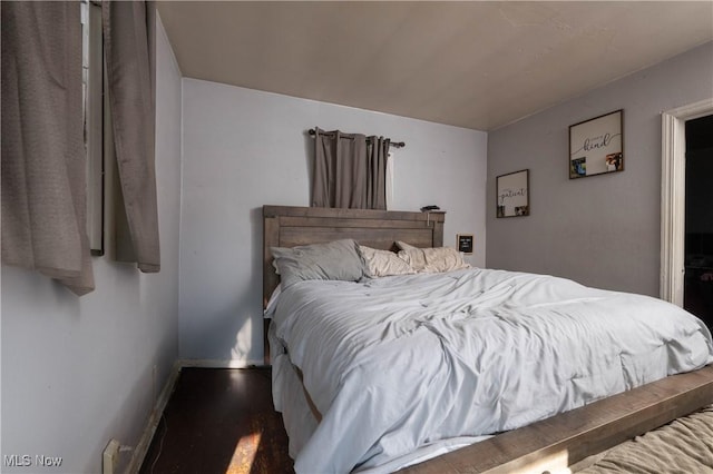 bedroom with wood-type flooring