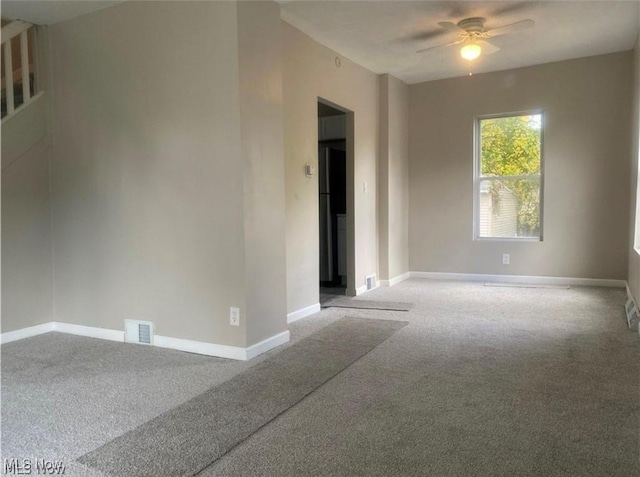 spare room with carpet and ceiling fan