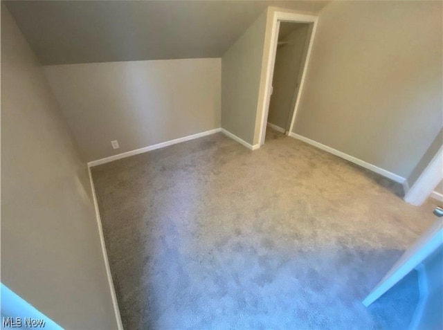 bonus room featuring carpet and lofted ceiling