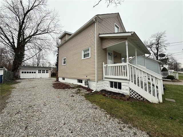 747 Brownell Ave, Lorain, OH 44052 - view of home's exterior with an outbuilding, a porch, and a detached garage