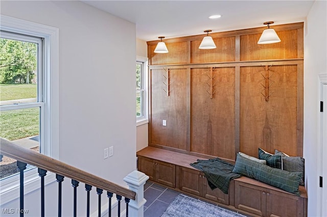 mudroom featuring dark tile patterned floors and a healthy amount of sunlight