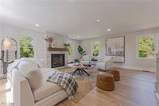 living room with a fireplace and light hardwood / wood-style flooring