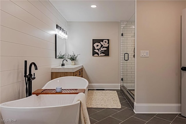 bathroom featuring tile patterned floors, vanity, and shower with separate bathtub