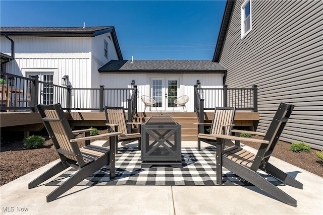 view of patio featuring french doors, an outdoor fire pit, and a wooden deck