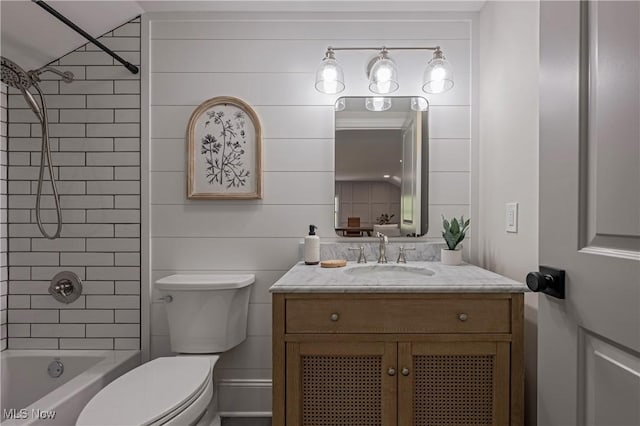 full bathroom with vanity, toilet, and tiled shower / bath combo