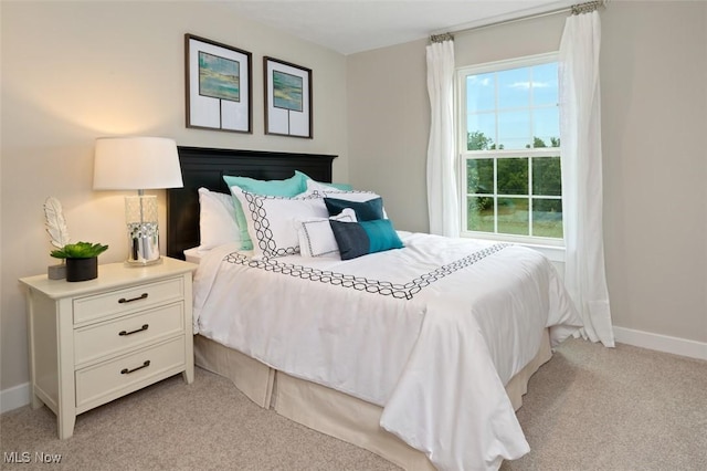 bedroom featuring light colored carpet