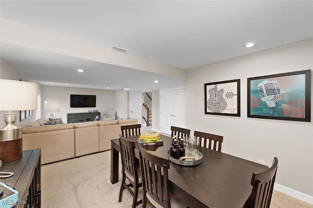 dining room featuring light carpet