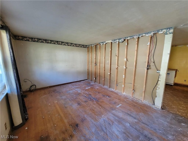 spare room with wood-type flooring