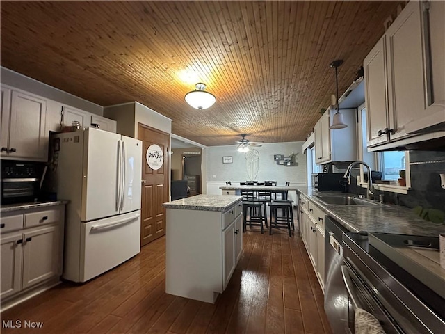 kitchen with wooden ceiling, white cabinets, appliances with stainless steel finishes, decorative light fixtures, and a kitchen island