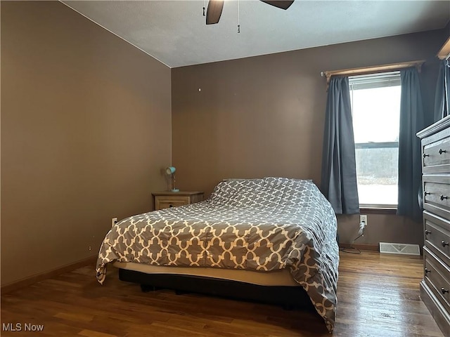 bedroom with multiple windows, light wood-type flooring, and ceiling fan