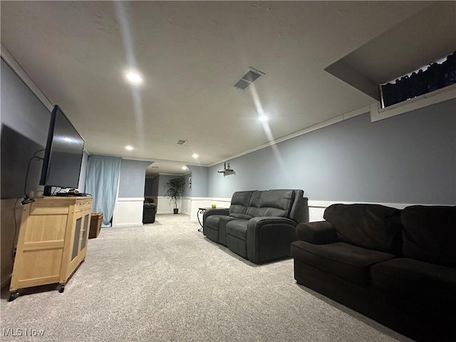 carpeted cinema room with crown molding