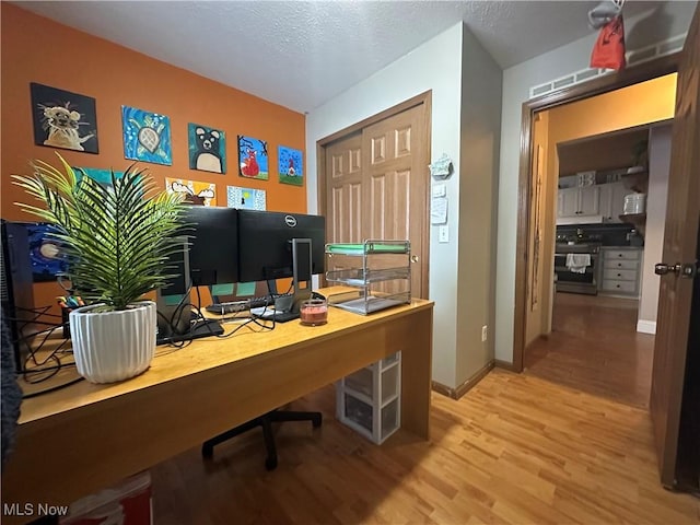 office space with a textured ceiling and hardwood / wood-style flooring