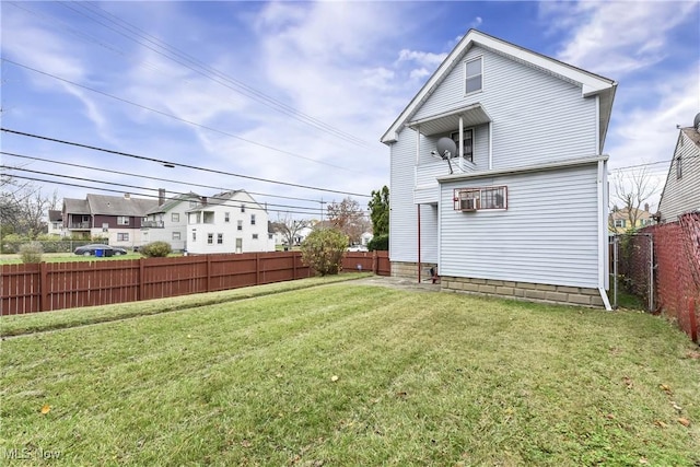 rear view of house featuring a yard