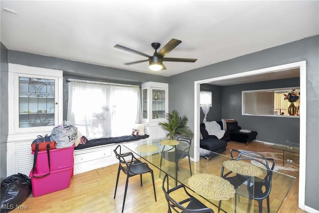 dining area featuring ceiling fan and light wood-type flooring