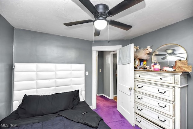 bedroom featuring a textured ceiling, carpet floors, and ceiling fan