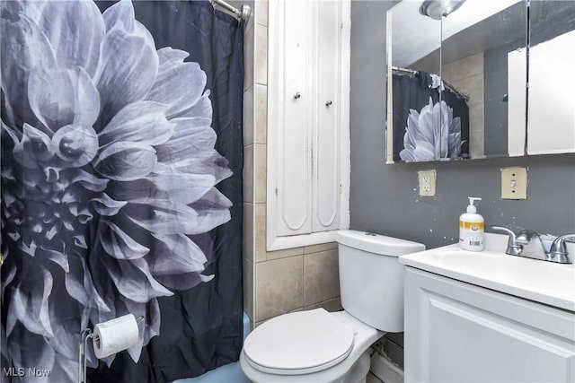 bathroom with walk in shower, vanity, and toilet