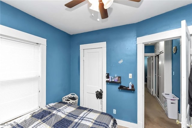 bedroom featuring ceiling fan and a closet