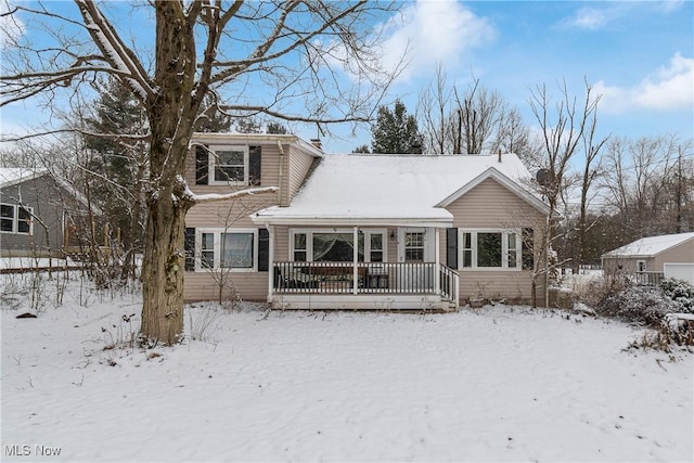 view of snow covered back of property