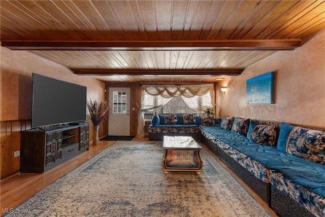 living room with beamed ceiling, wood ceiling, and hardwood / wood-style flooring