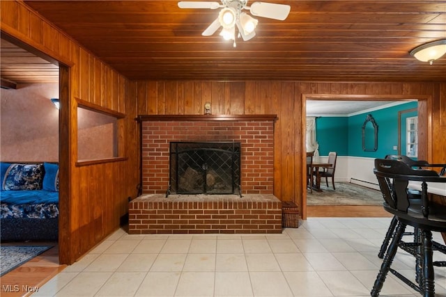 living room featuring wooden ceiling, a fireplace, and wooden walls