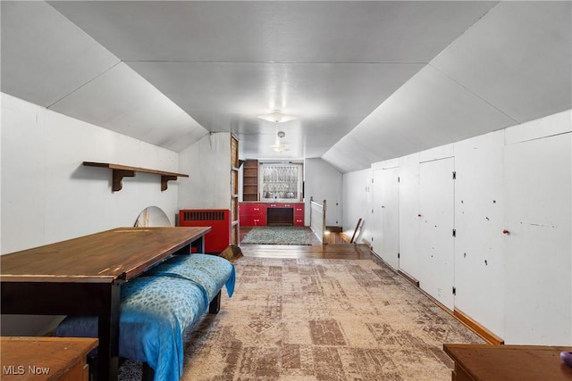 bedroom featuring carpet floors and vaulted ceiling