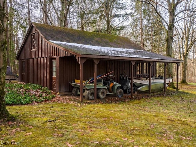 view of outdoor structure featuring a lawn