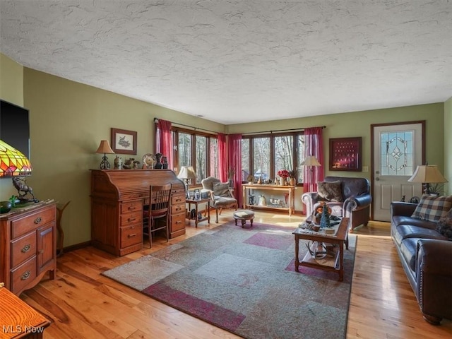 living room featuring light hardwood / wood-style floors and a textured ceiling