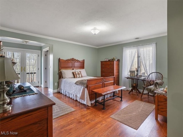 bedroom featuring access to outside, french doors, wood-type flooring, and multiple windows