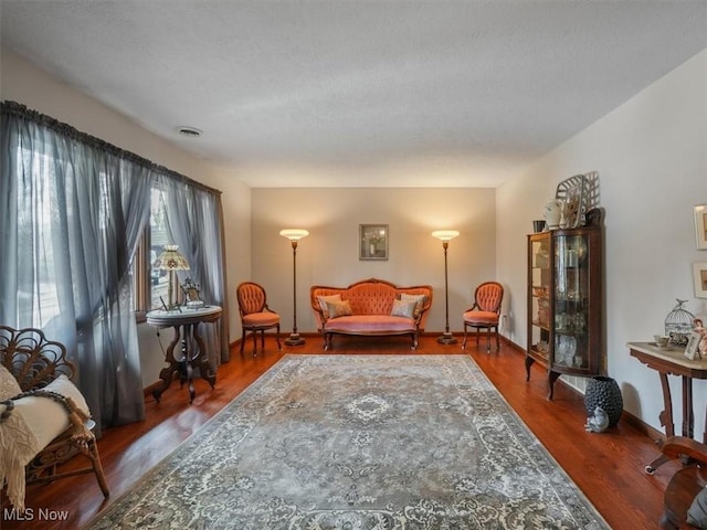 sitting room with wood-type flooring and a textured ceiling