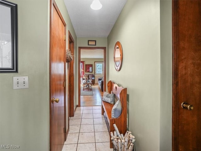 hall featuring light tile patterned floors