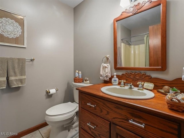 bathroom with toilet, curtained shower, tile patterned floors, and vanity