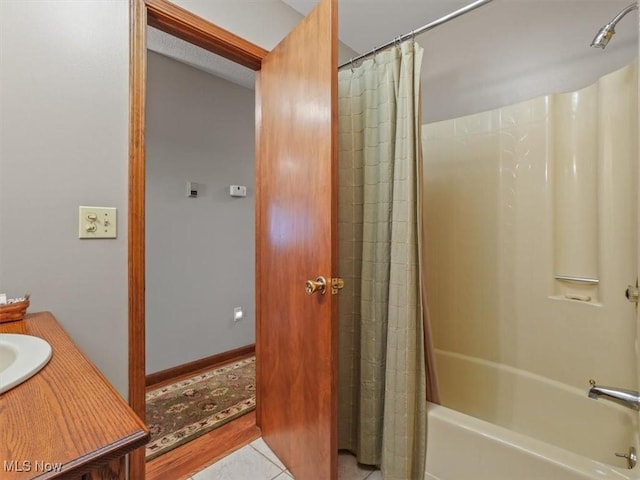 bathroom featuring vanity, shower / tub combo with curtain, and tile patterned floors