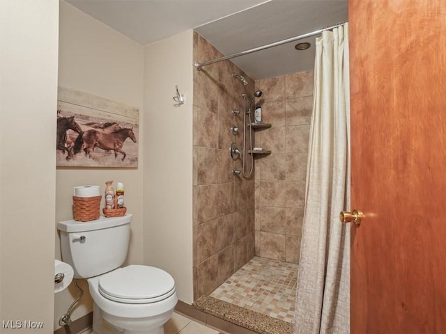 bathroom featuring toilet, walk in shower, and tile patterned floors