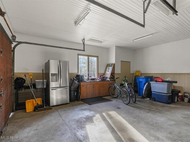 garage with stainless steel fridge