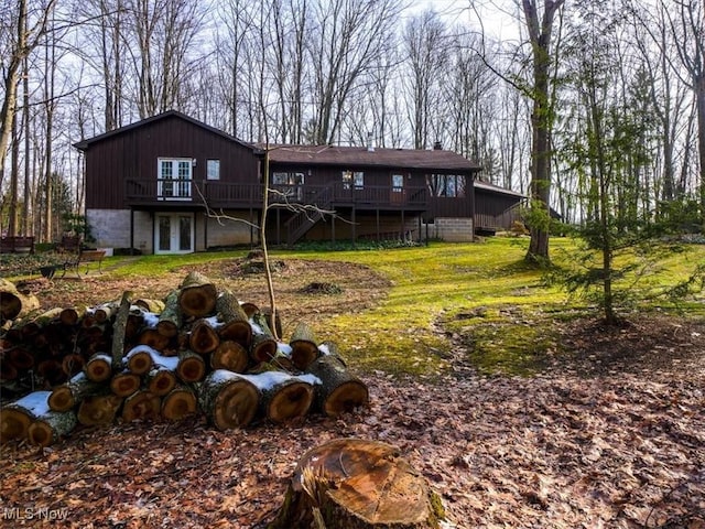 rear view of property featuring a wooden deck