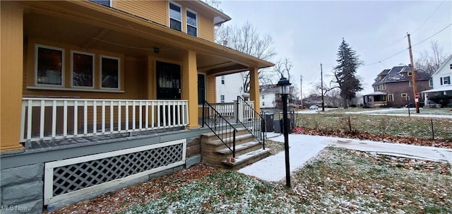 view of snowy exterior with a porch