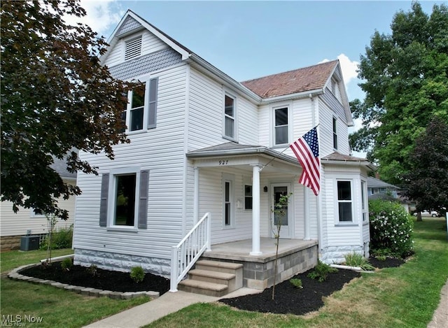 view of front facade with covered porch, a front lawn, and cooling unit