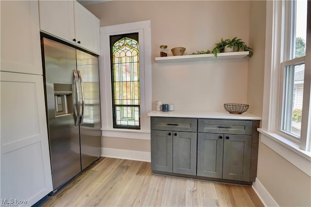 interior space featuring gray cabinetry, white cabinets, stainless steel refrigerator with ice dispenser, and light wood-type flooring