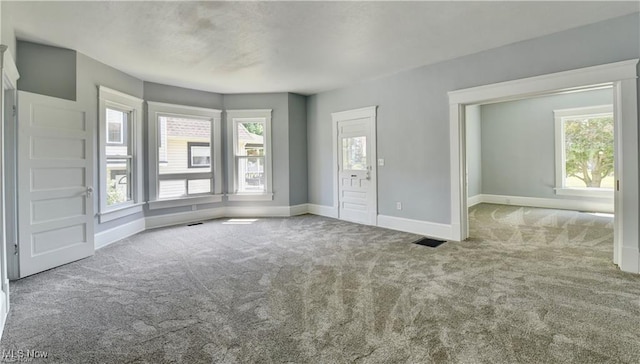 unfurnished living room with light carpet