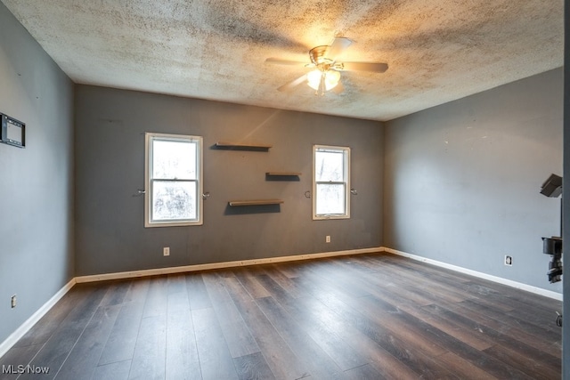 unfurnished room with a textured ceiling, dark hardwood / wood-style floors, and ceiling fan