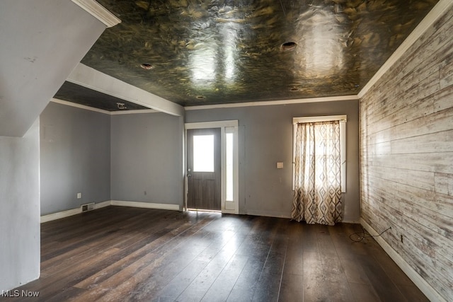 foyer entrance with dark hardwood / wood-style flooring and crown molding