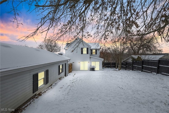 snow covered rear of property with central air condition unit