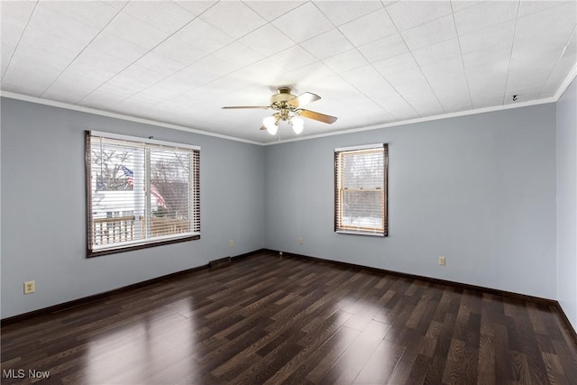 spare room with dark hardwood / wood-style flooring, ceiling fan, and ornamental molding