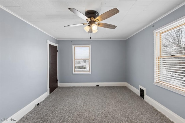 empty room with carpet flooring, ceiling fan, and ornamental molding