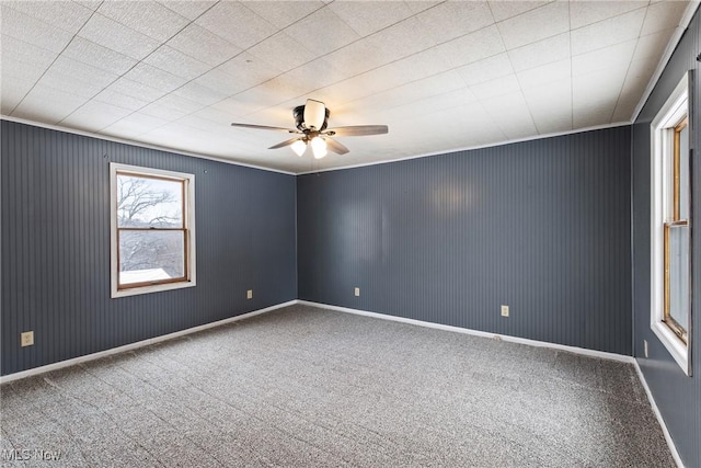 unfurnished room with carpet floors, ceiling fan, and ornamental molding