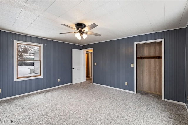 unfurnished bedroom featuring ceiling fan, a closet, and carpet floors